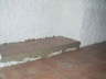 Bedroom showing the tiled base of the built-in wardrobes